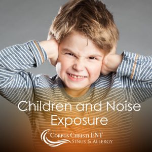 Young boy covering his ears to block out loud noises